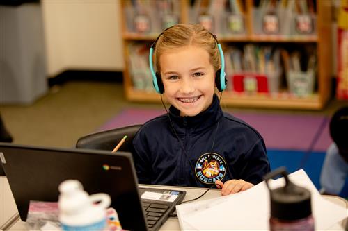 Student with headset and laptop