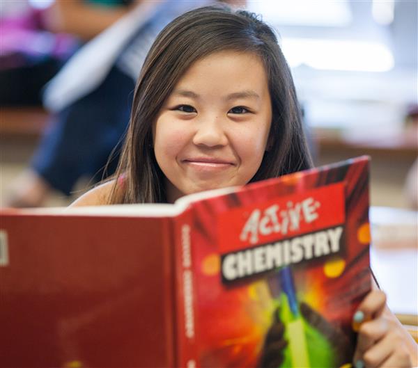 Student reading chemistry book